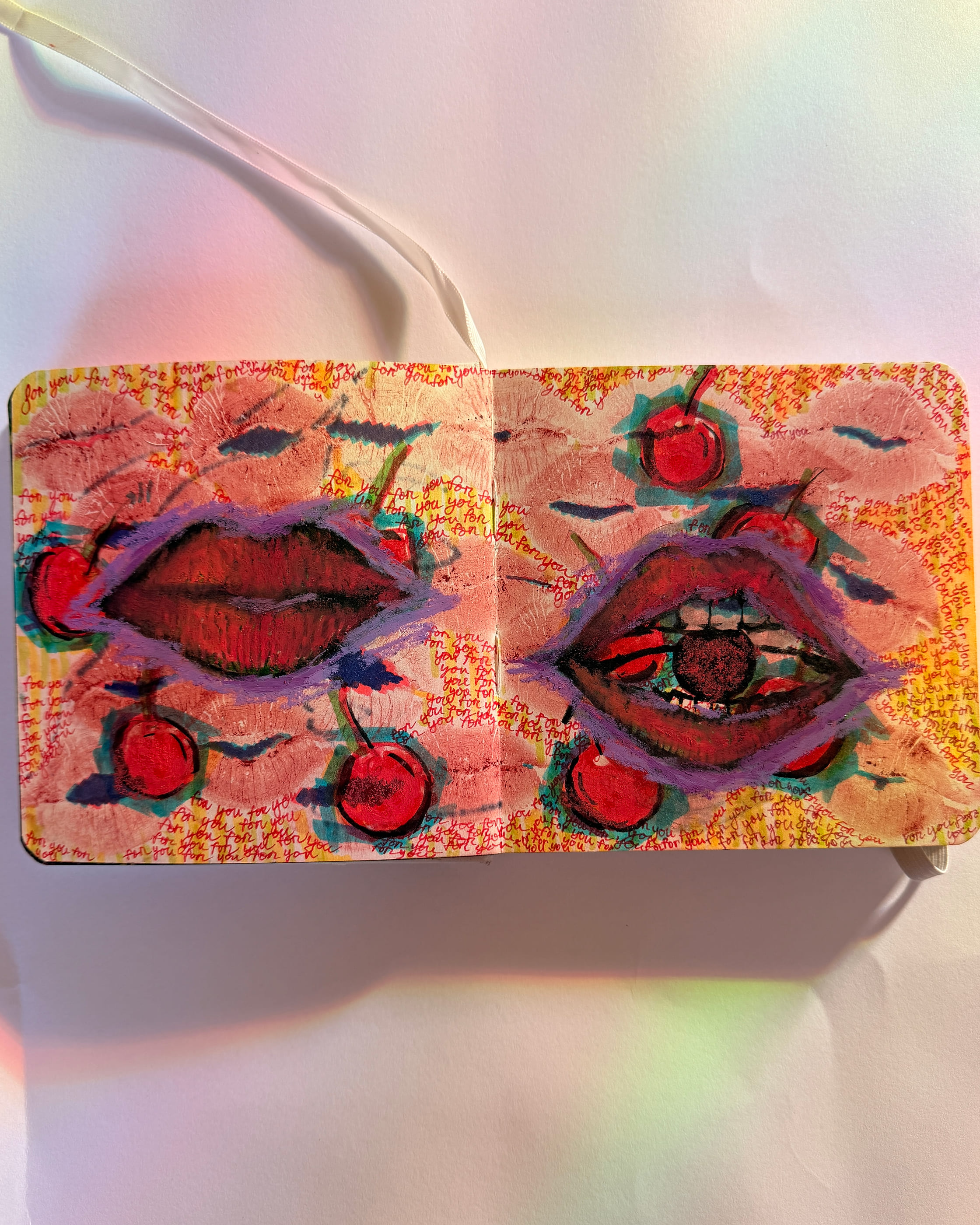 Two heavy red mouths, one closed and one biting a dark cherry, float among scattered cherries and lipstick prints on a blush ground. The words 'for you' are written over and over in red ink across every inch of the open sketchbook spread.