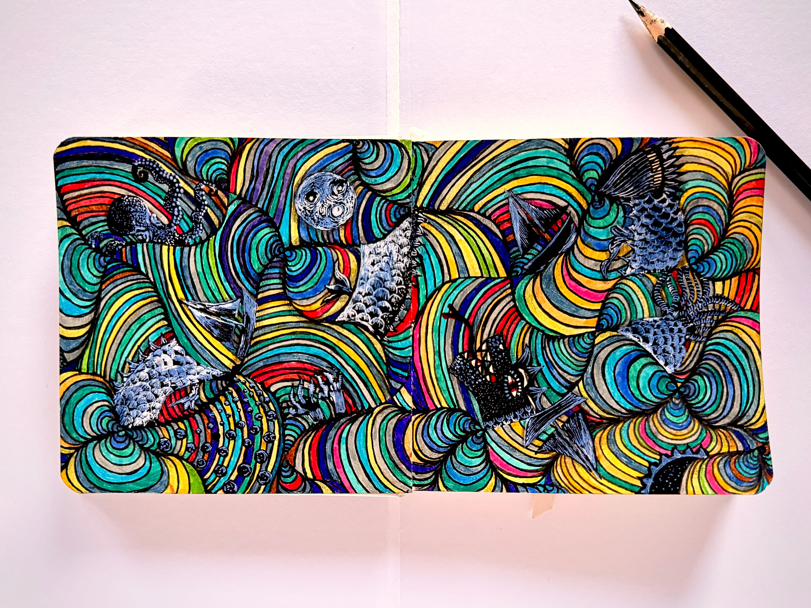 Dense concentric rings of colour fill an open sketchbook spread like a churning sea. Sailing boats, fish, a spotted octopus and a pale many-eyed moon are worked into the waves in fine black ink and white gouache.