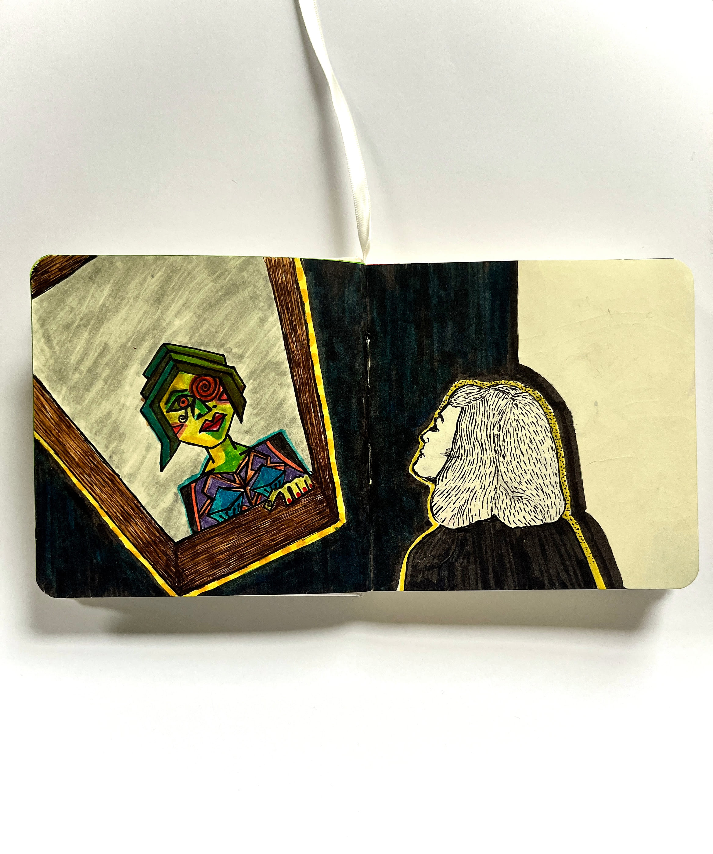 On the left page of an open sketchbook, a wooden mirror reflects a face fractured into cubist planes of green, orange and blue. On the right, drawn in fine ink hatching and outlined in yellow, sits the woman actually looking into it, in near darkness.